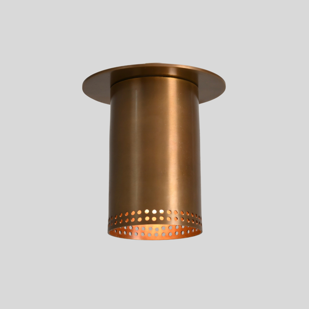 Brass flush mount spotlight with perforated rim in antique brass, front view