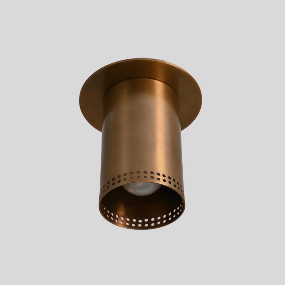 Brass flush mount spotlight with perforated rim, detail of the shade