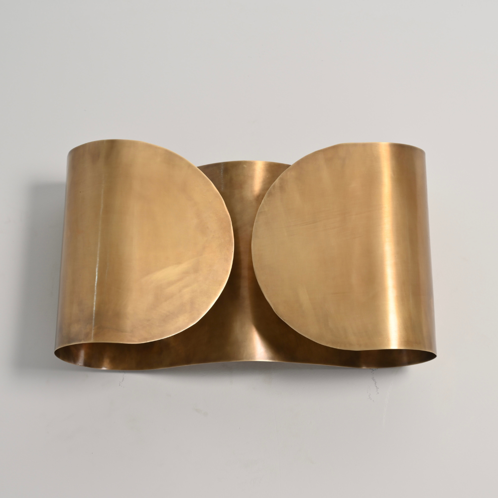 brass curved shade 2 light butterfly wall lamp on gray background by Lightcove