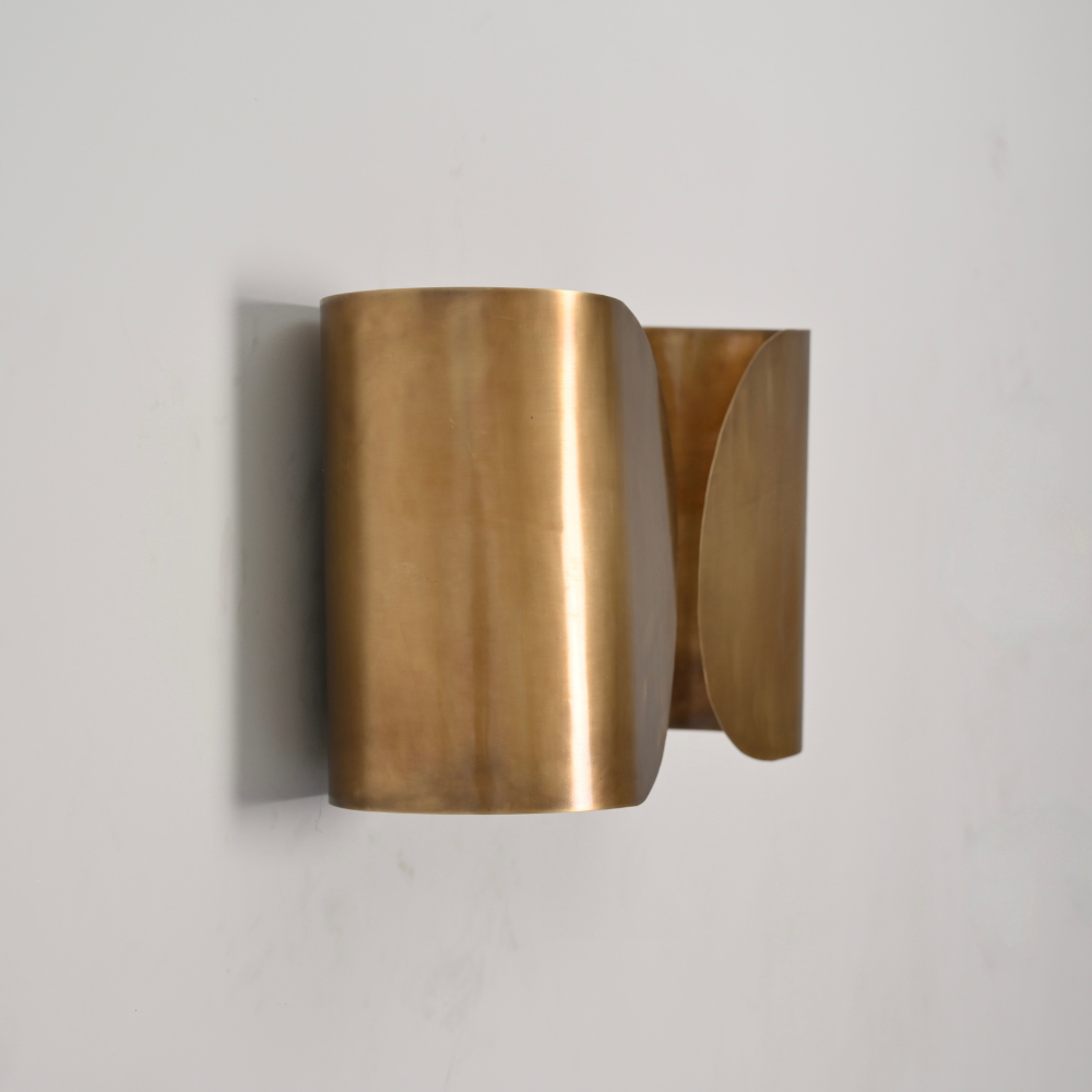 Brass wall sconce on a light gray background in a butterfly design