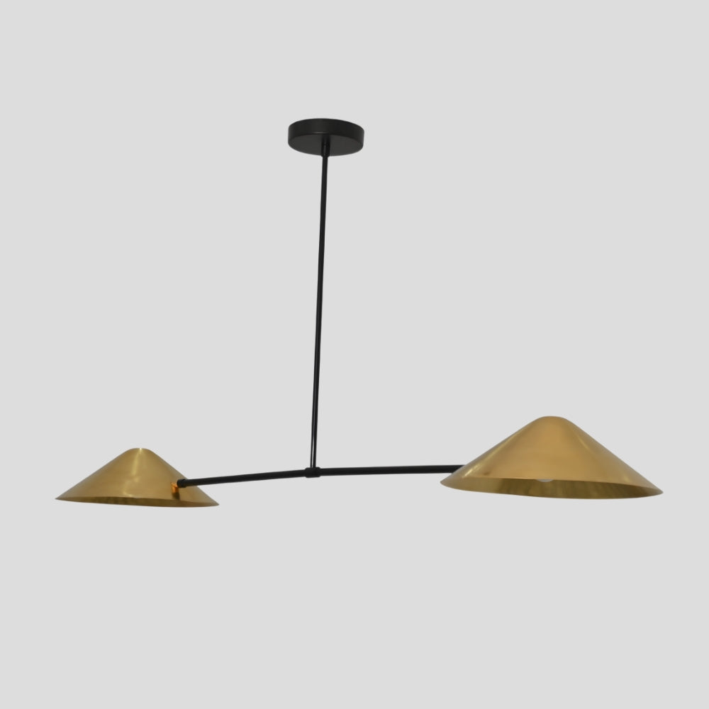 Modern pendant light with two brass shades on a gray background