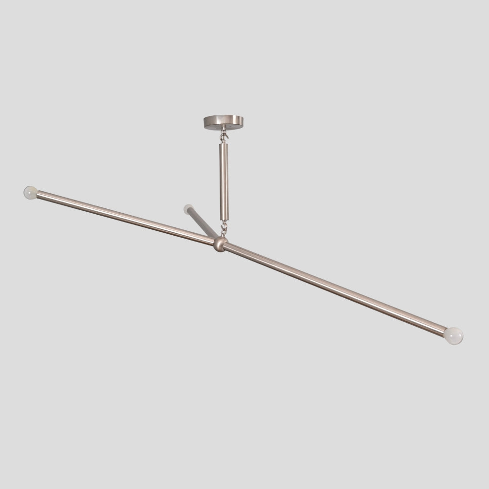 Brass ceiling mounted curtain rod system on a light gray background