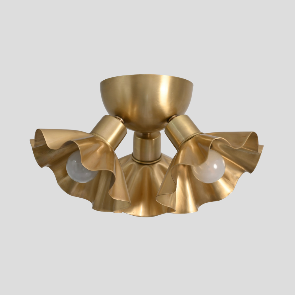 mid century brass flower flush mount on a gray background