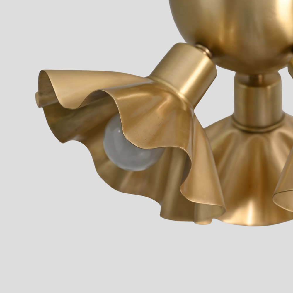 close up on the brass flower shade of an handcrafted flush mount