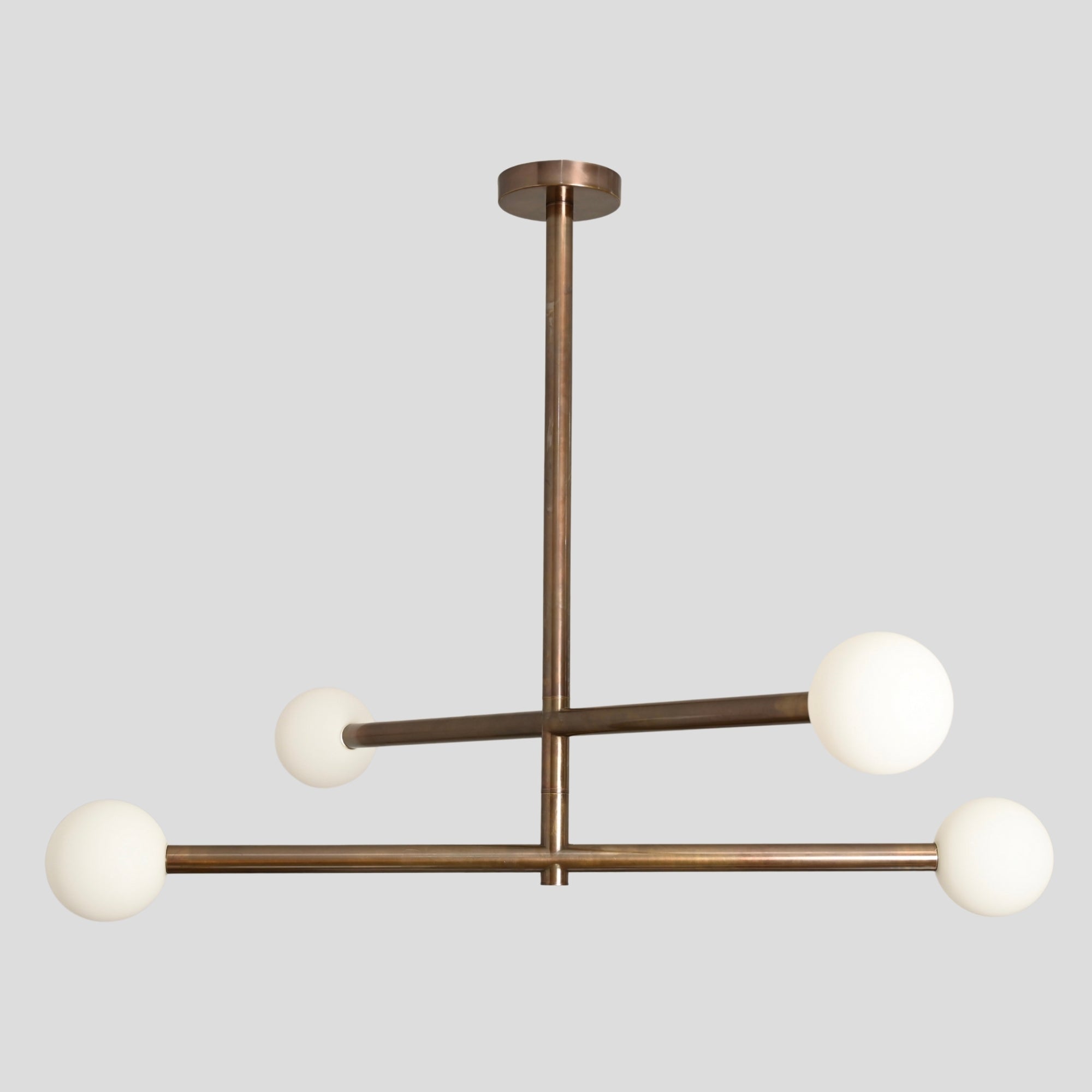 Four glass globe ceiling light with an antique brass finish, a handmade piece by lightcove