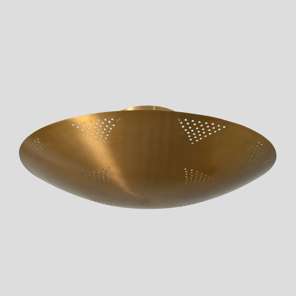 Gold decorative object with perforated design on a gray background