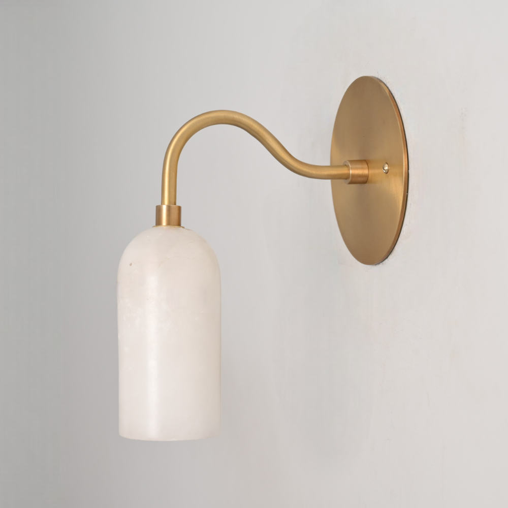 Mid century brass curved alabaster wall sconce on white wall