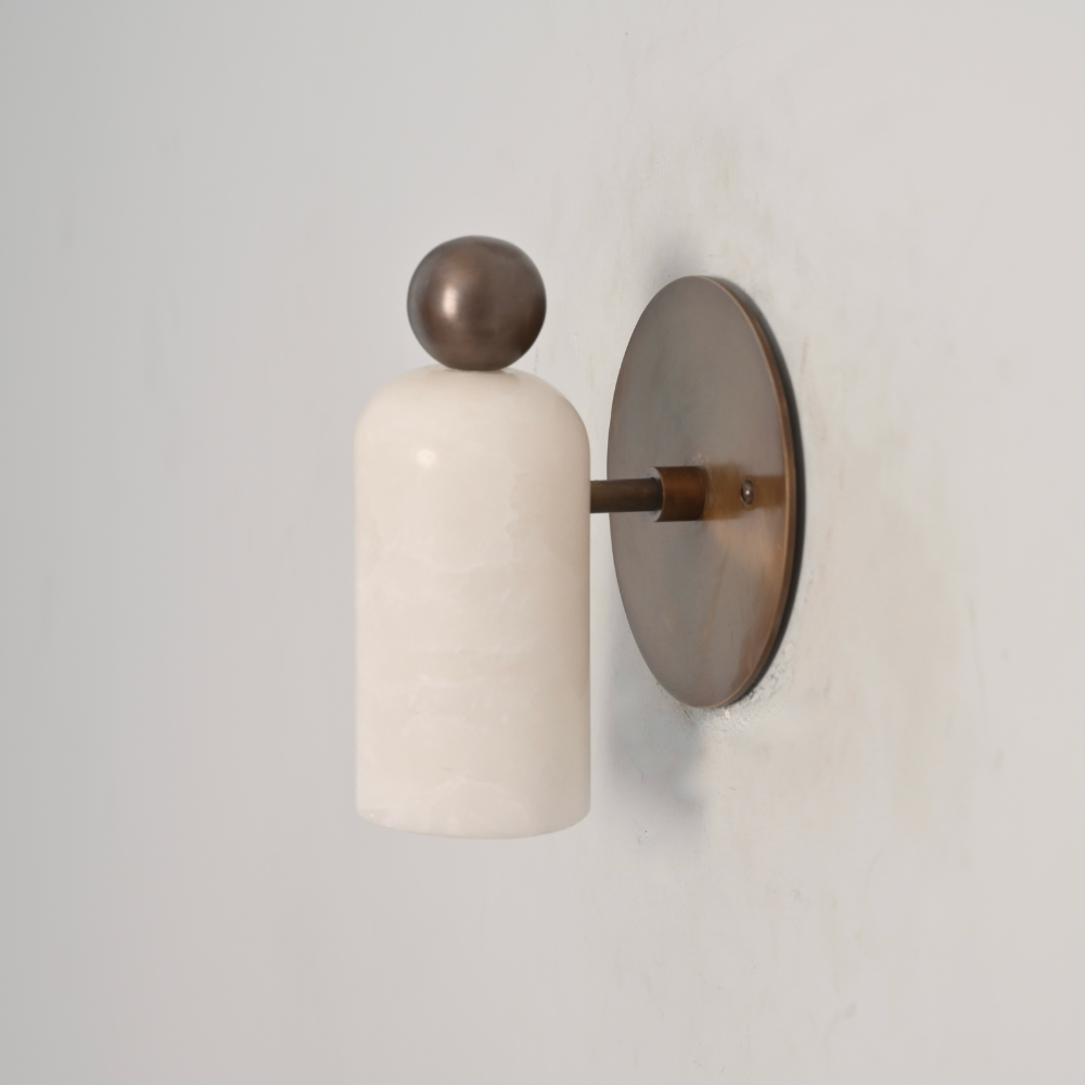 Modern brass ball alabaster wall light on gray wall