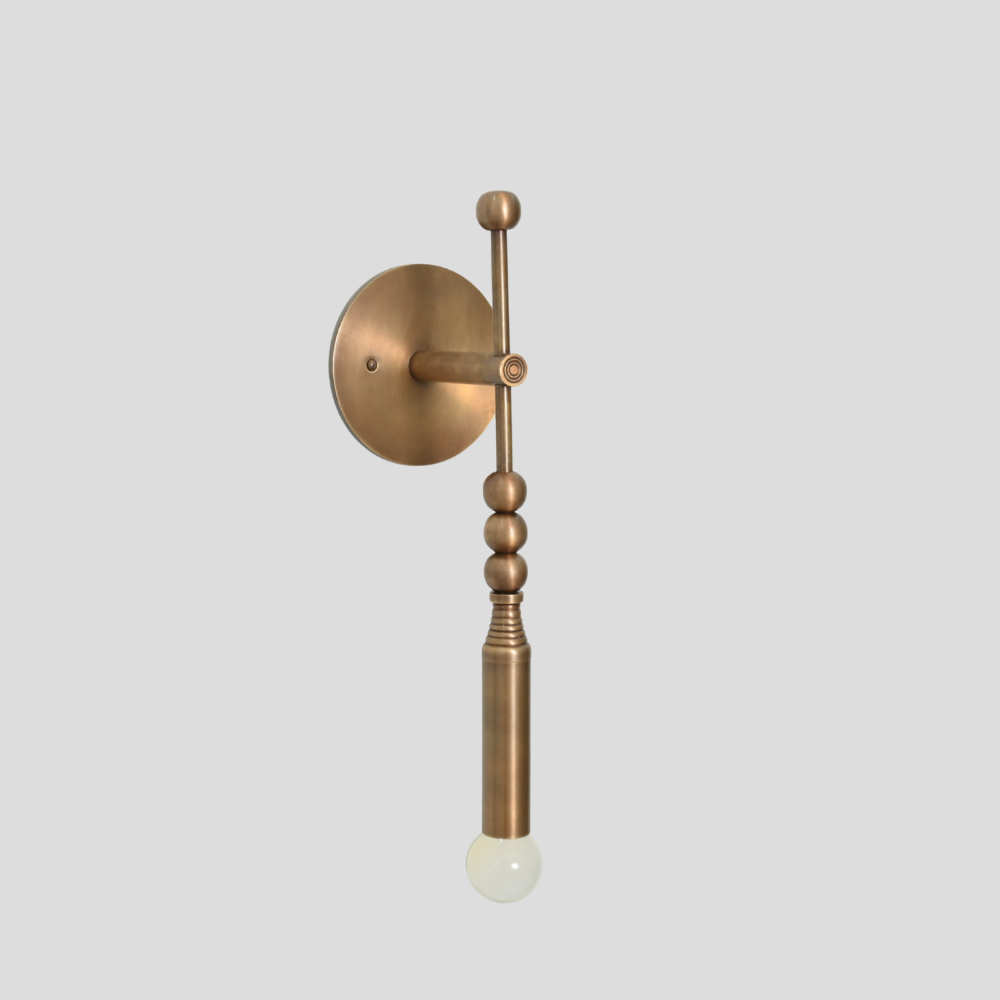 Brass vertical arm with a premium glass globe on a gray background