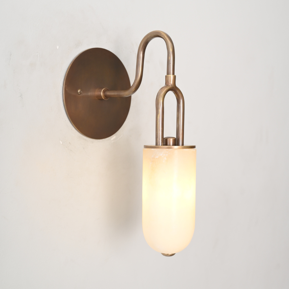 Handcrafted alabaster wall lamp mounted on white wall