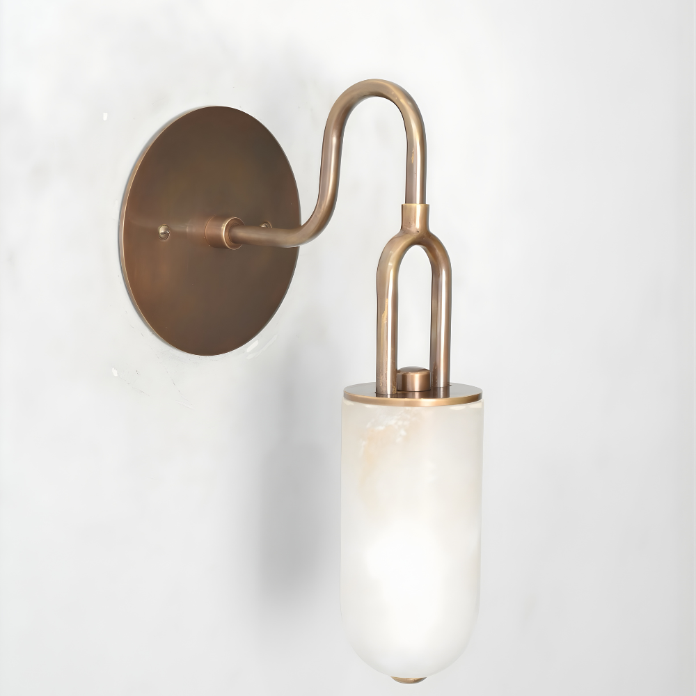 Brass wall sconce with a marble shade on a white background