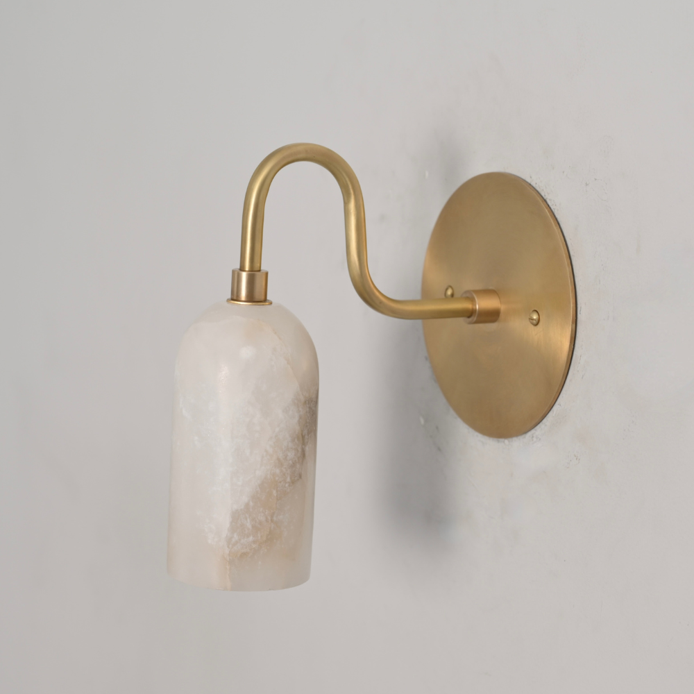 Luxury alabaster wall light with soft warm glow and brass mount