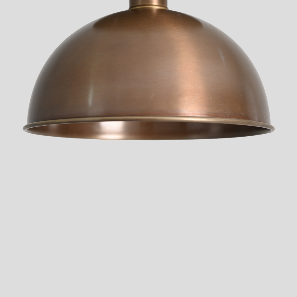 Close up on the antique brass finish of a minimalist semi flush mount