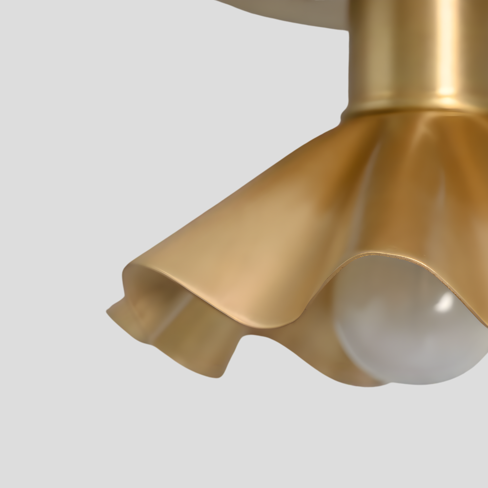 Close up on the raw brass finish of a flower ceiling light on a gray background