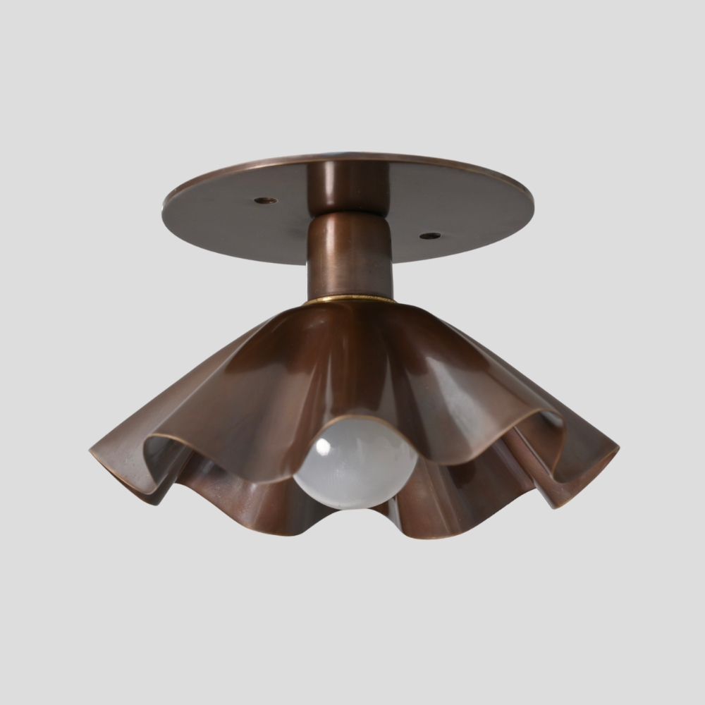 Antique brass flower semi flush mount on gray background