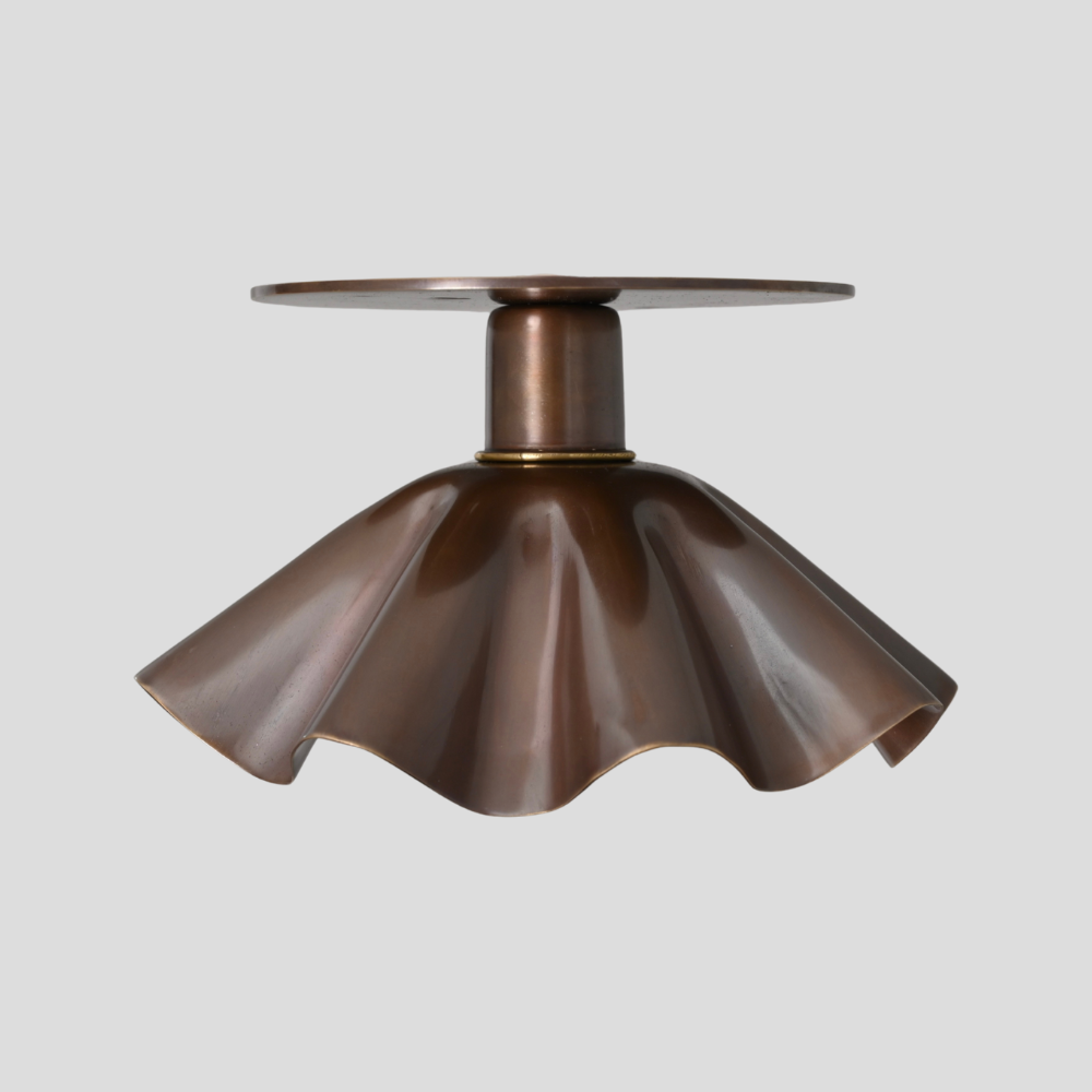 Minimalist modern flower shaped shade flush mount in a pure antique bras finish