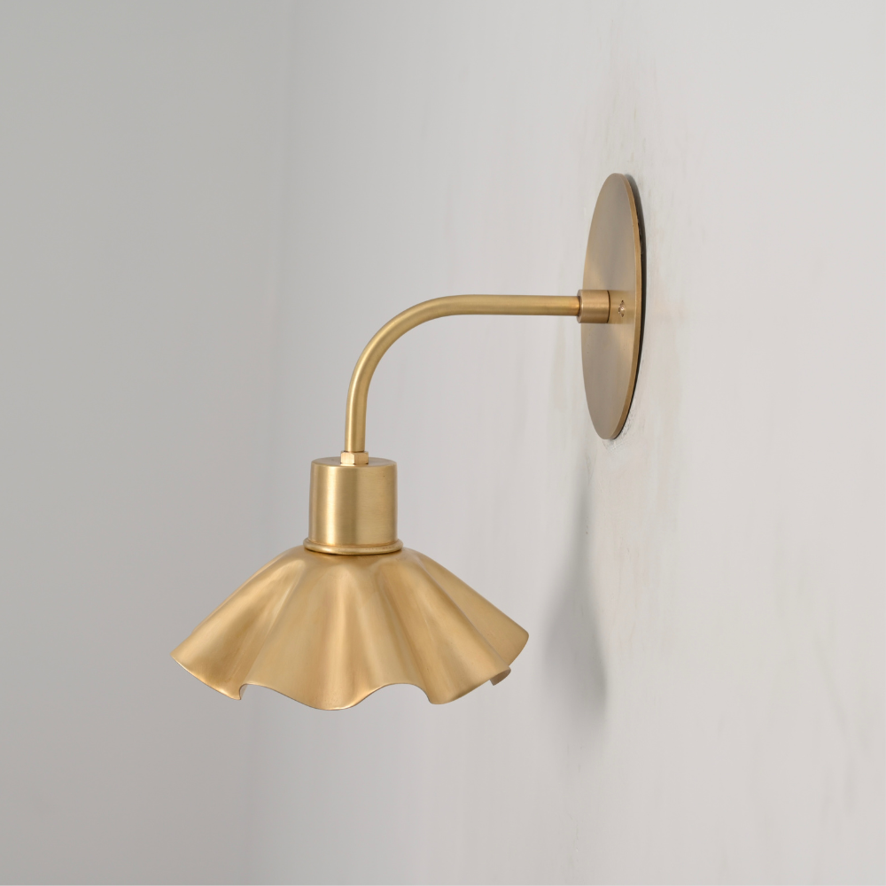 Vintage modern brass flower wall lamp on a gray wall