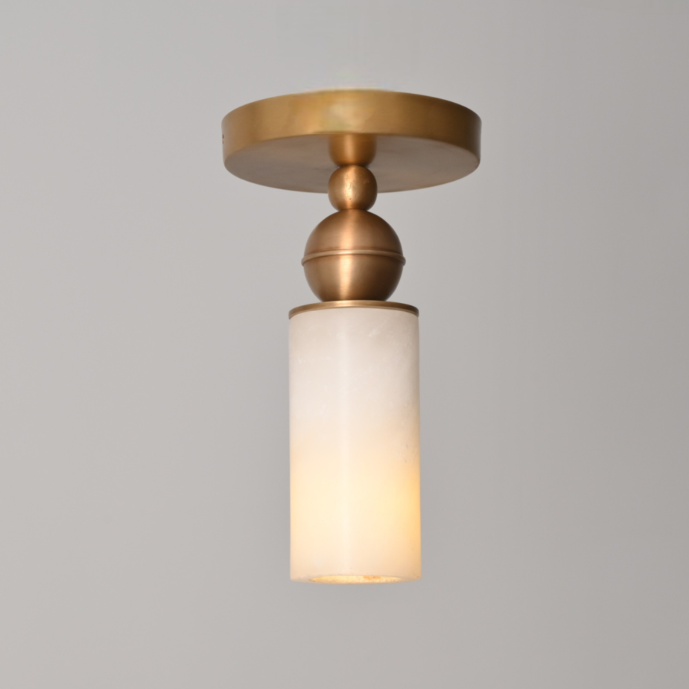 Modern alabaster cylinder flush mount light with warm brass finish