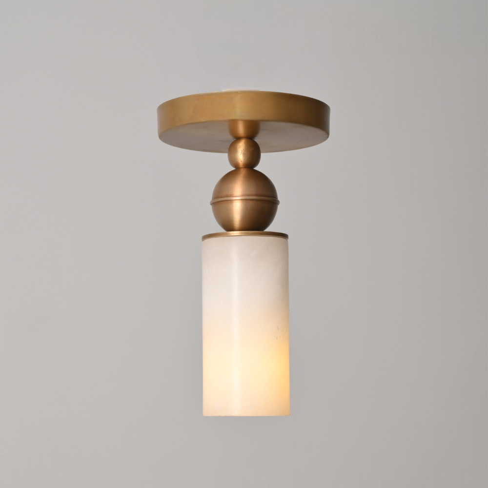 Elegant alabaster cylinder ceiling light with brushed brass flush mount canopy