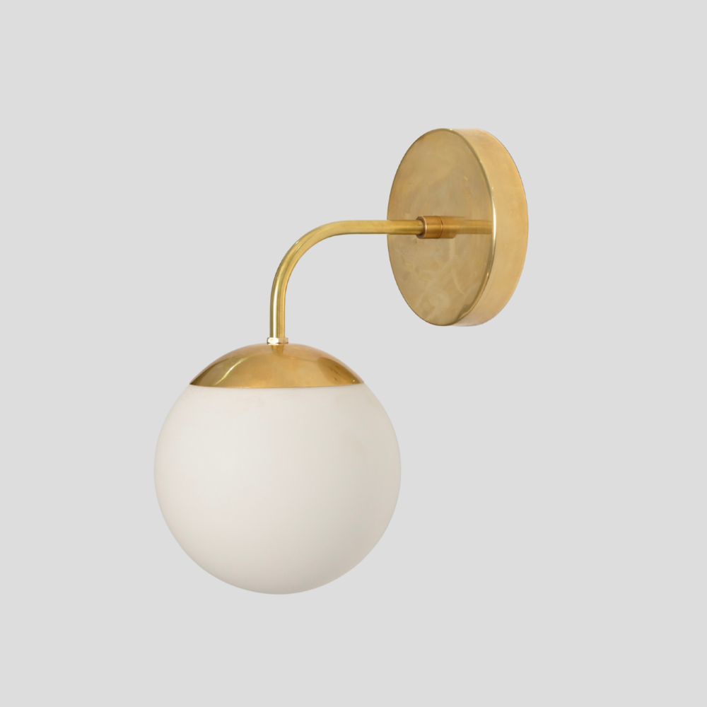 Brass wall lamp in a modern design with a curved arm