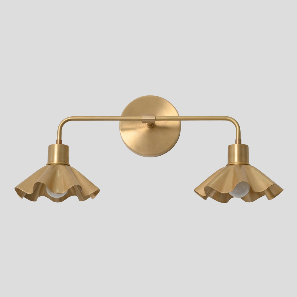 Mid century vanity light with 2 brass petal shade on a gray background