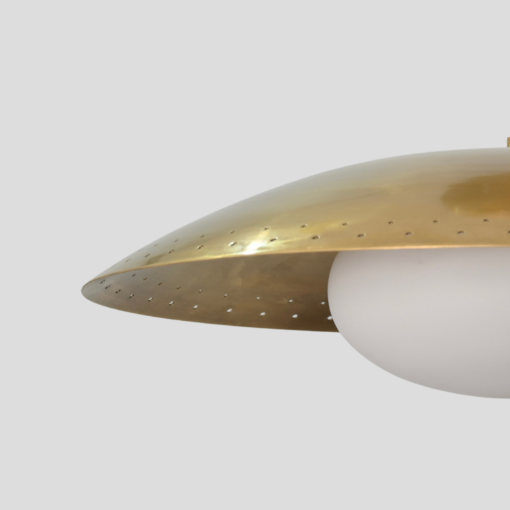Close-up detail of Perforated Brass Dome Ceiling Light - Glass Globe Pendant showing perforated dome shade in raw brass finish and white glass globe.