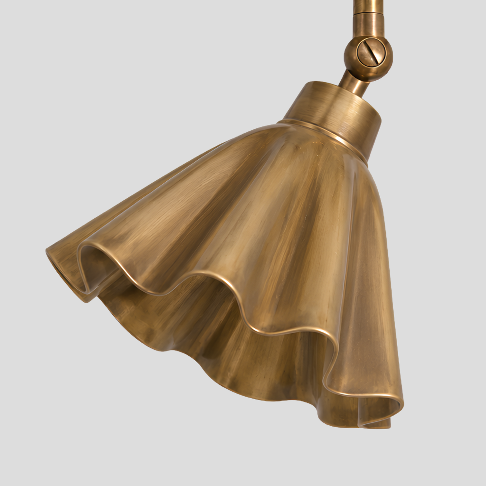 Close-up detail view of Ruffled Brass Flower Spot Light - Adjustable Ceiling Light showing sculptural fluted trumpet shade with ruffled edges, brass cylindrical connector with articulating swivel ball joint, and directional adjustment.