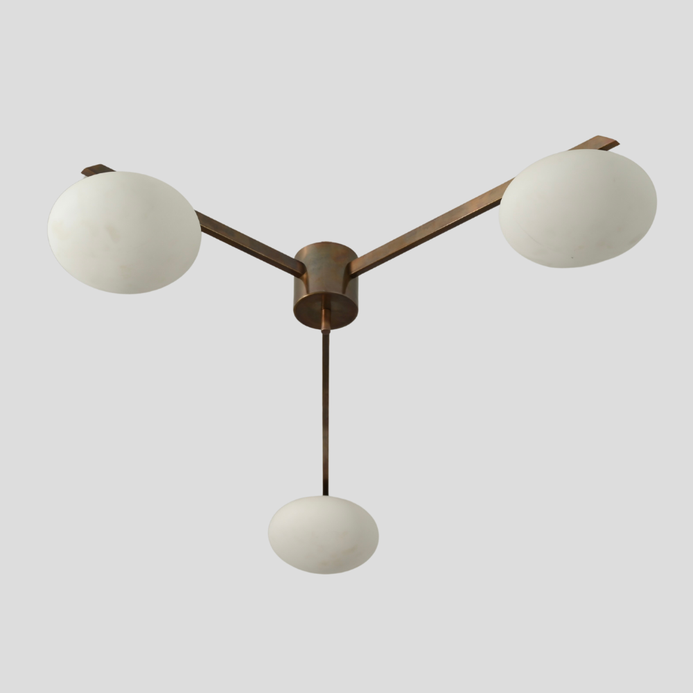 Modern ceiling light fixture with three spherical bulbs on a plain background