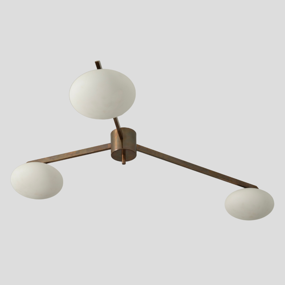 Mid century modern 3 brass frosted globe flush mount with an antique brass finish.
