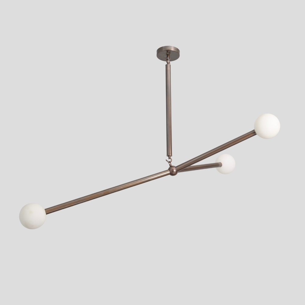 Modern Brass balanced ceiling light with 3 brass glass globe on a gray background