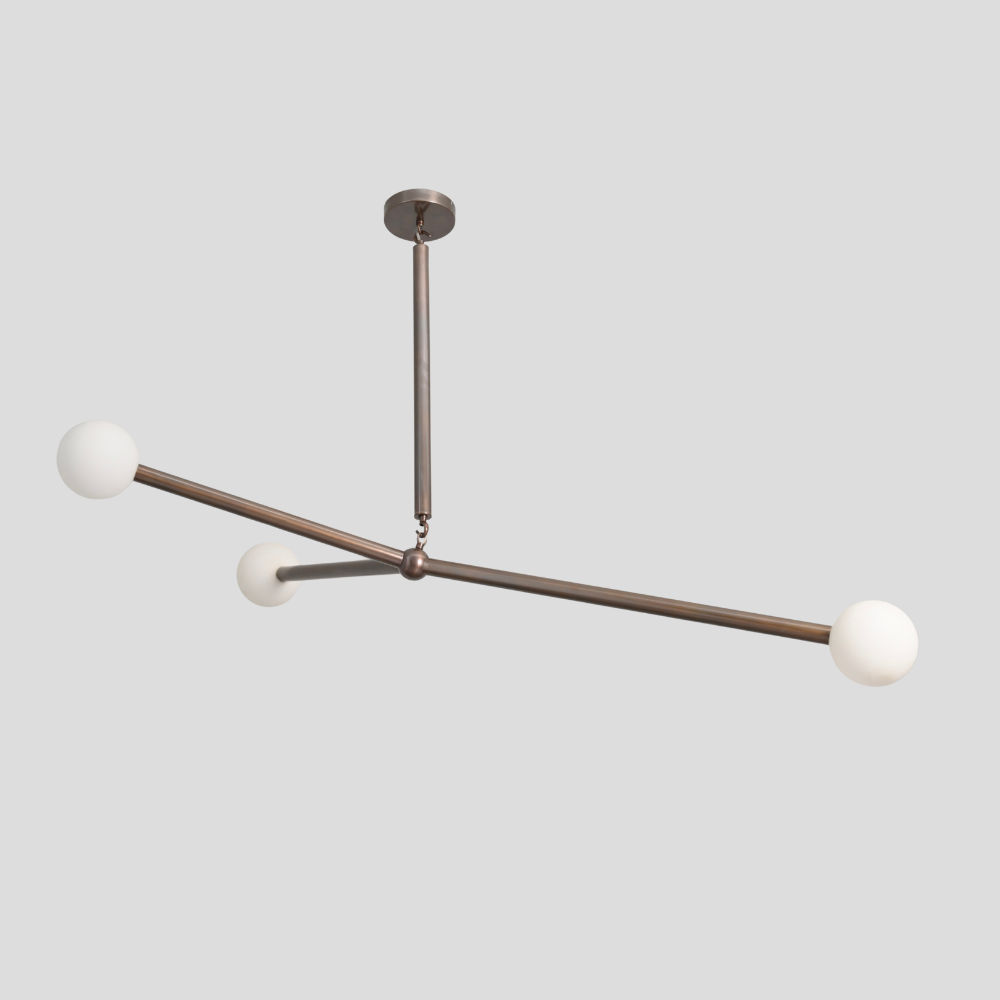 Three opal glass globe on a antique brass balanced vintage ceiling light designed by LightCove