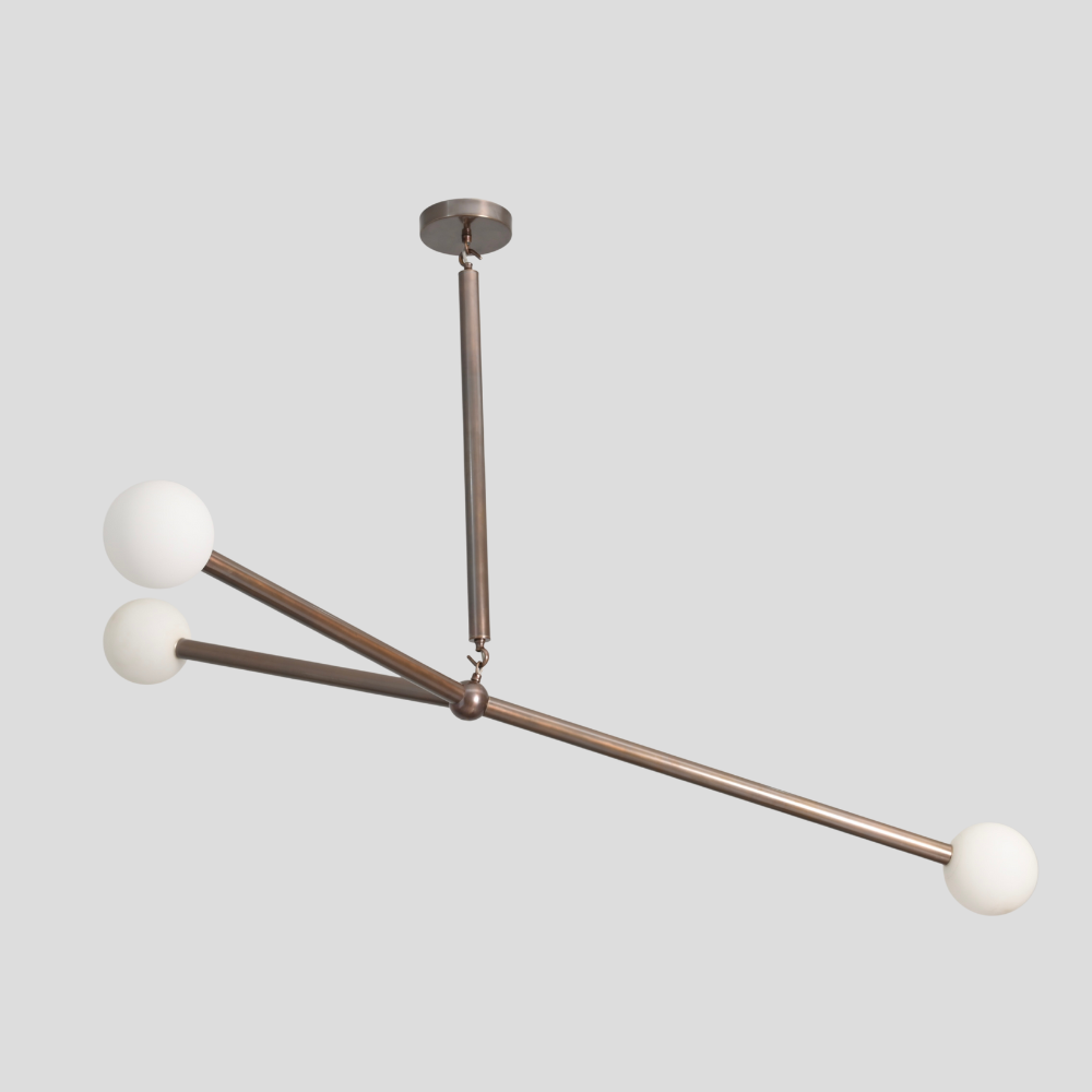 Mid century antique brass minimalist 3 light with a balanced globe arm chandelier on a gray background