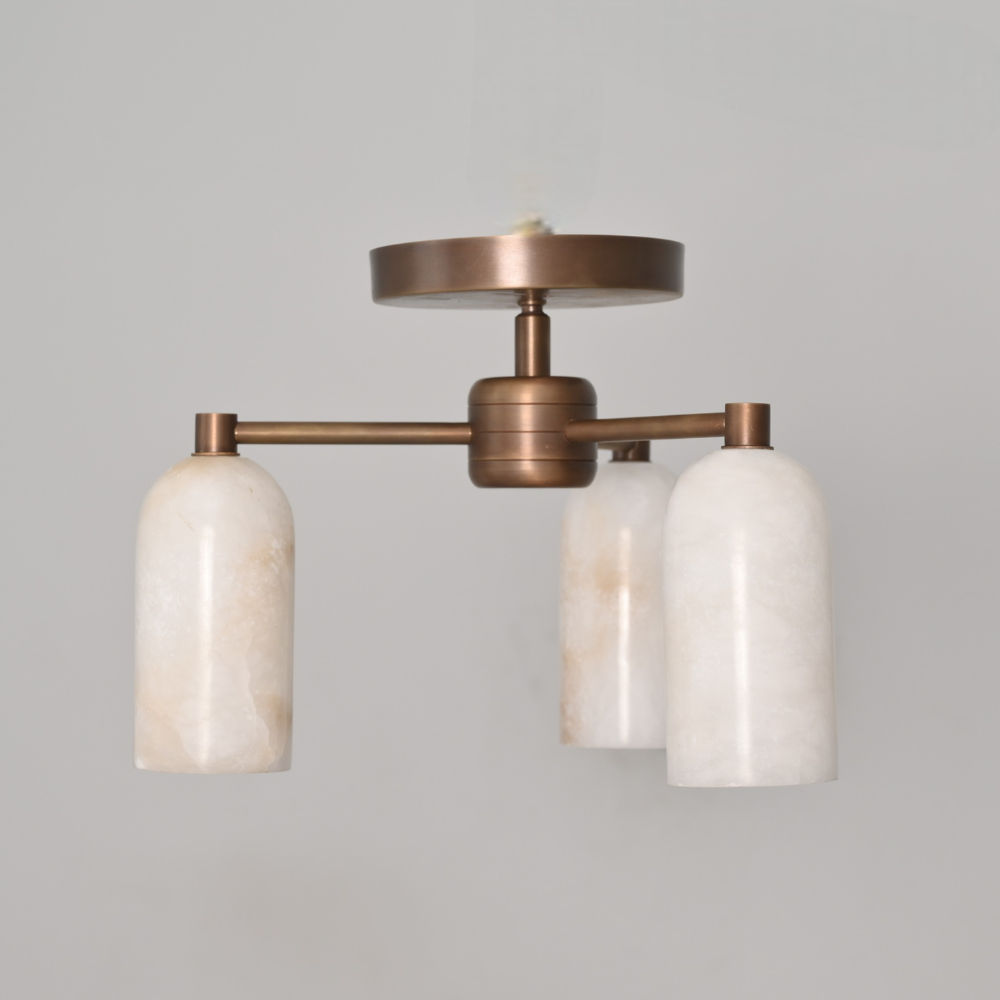 Brass flush mount with three alabaster marble shades