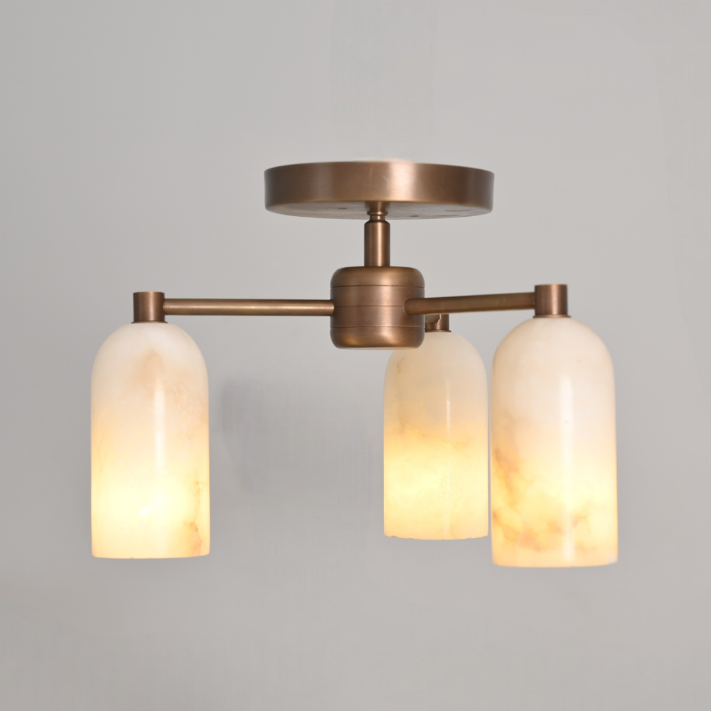 Mid century inspired brass alabaster flush mount in a warm lighting