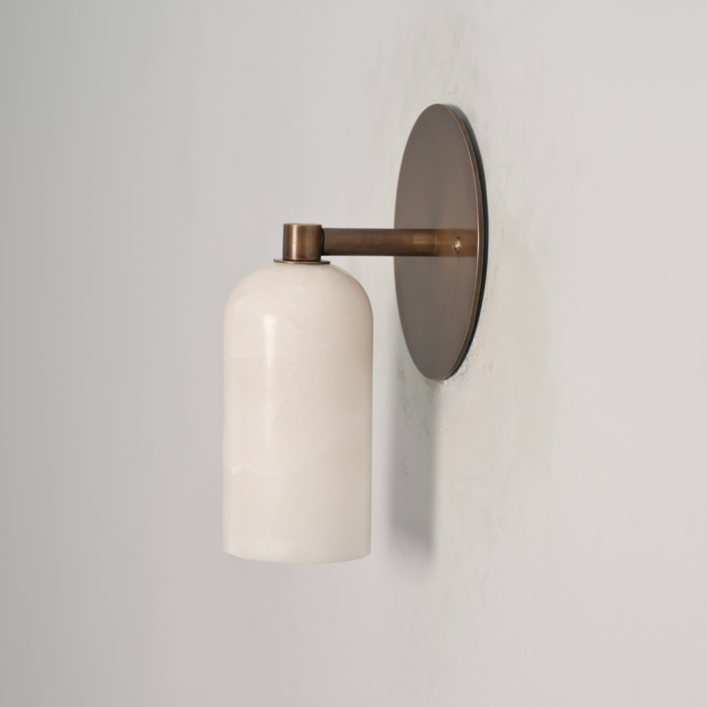 Minimalist brass alabaster wall sconce handcrafted in a mid century design.