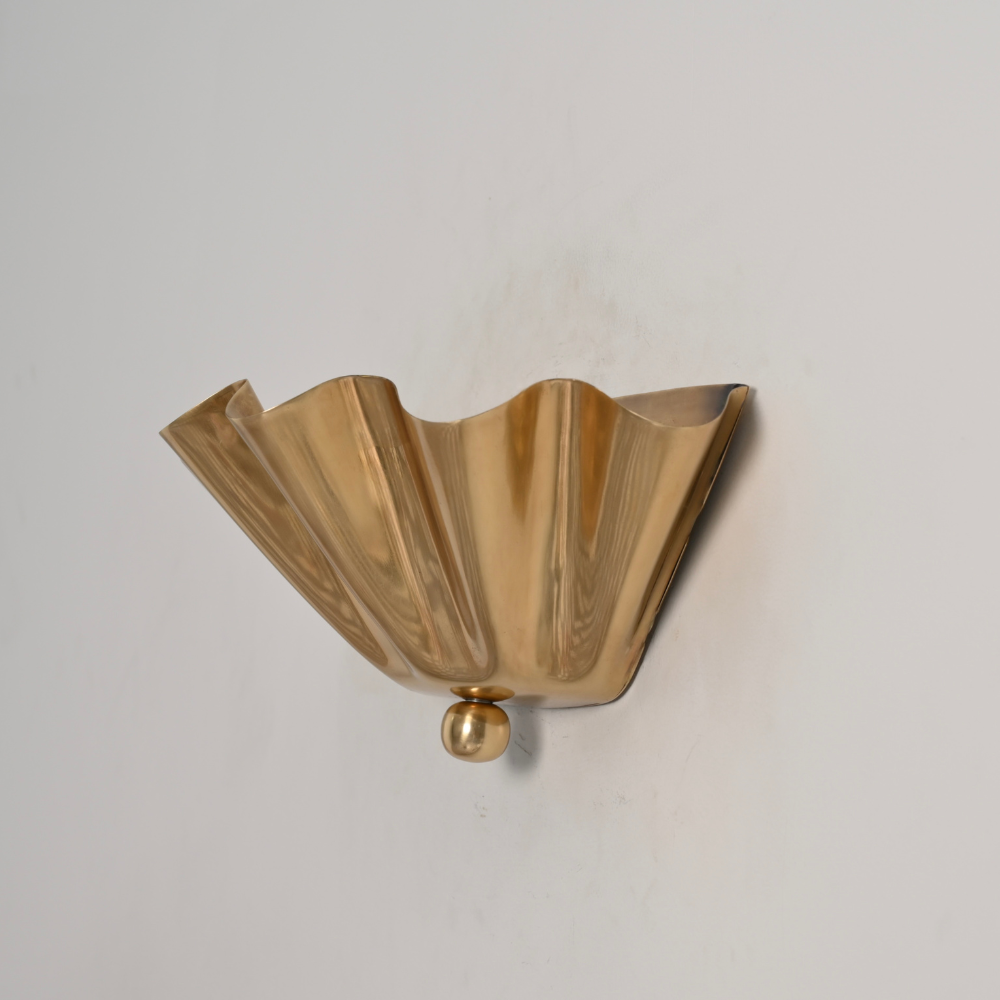 Modern brass finial shade wall sconce on gray wall