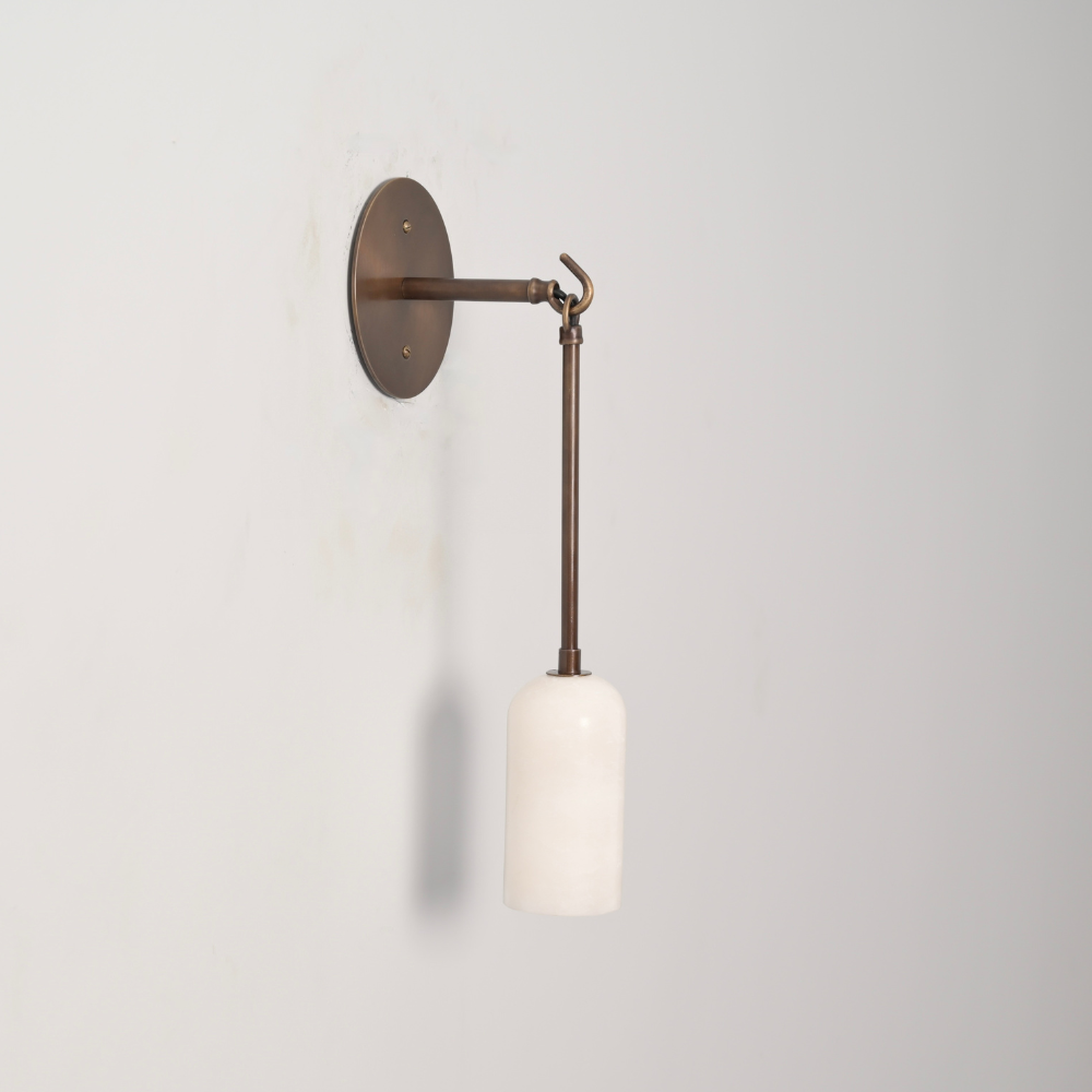 Pendant rod with a marble shade on a gray wall