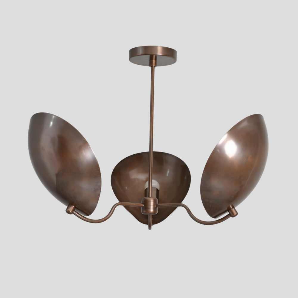 Brass chandelier with three oval shades on a gray background