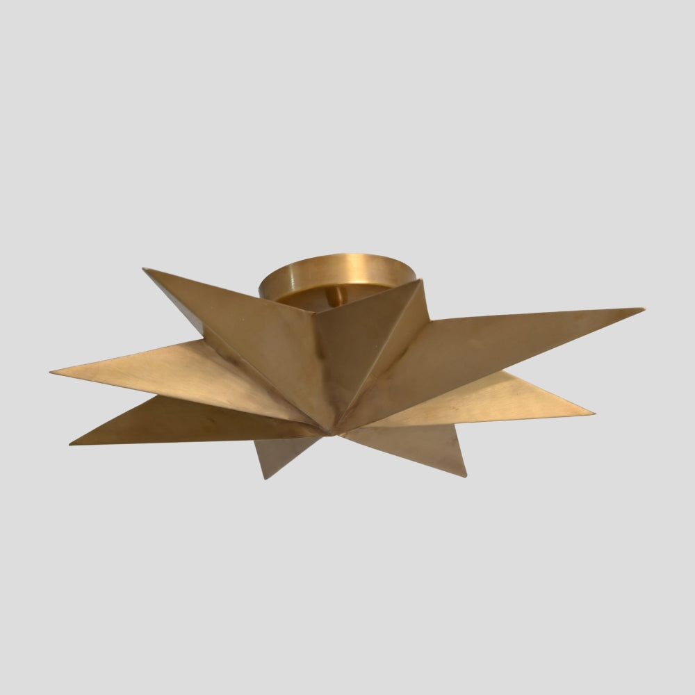 Gold ceiling light fixture with star-shaped design on a gray background