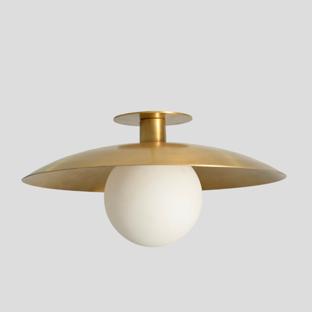 Modern flush mount with frosted glass globe on a grey background. 