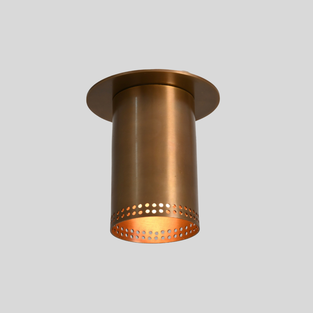 Brass flush mount spotlight with perforated rim, view from below