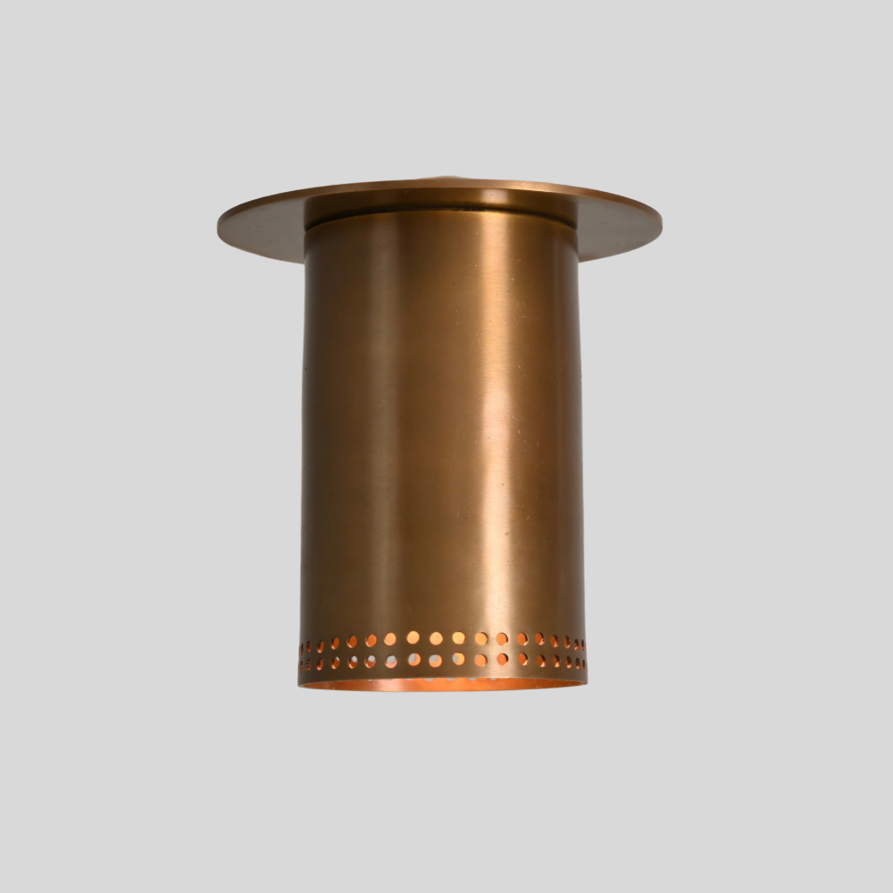 Brass flush mount spotlight with perforated rim, close-up of the finish