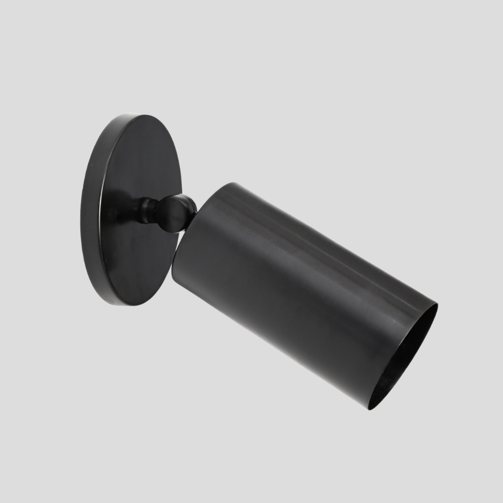 Black wall-mounted light fixture on a gray background