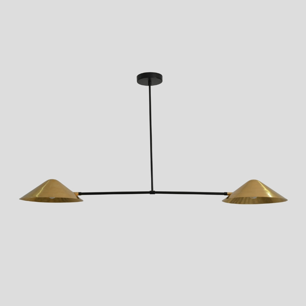 Modern pendant light with raw brass lampshades on a gray background