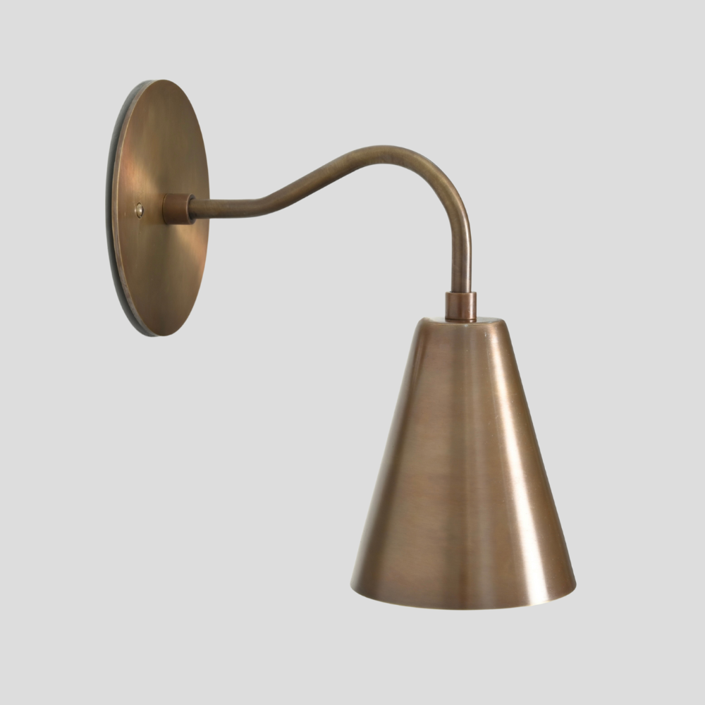 Bronze wall sconce with a curved arm on a light gray background