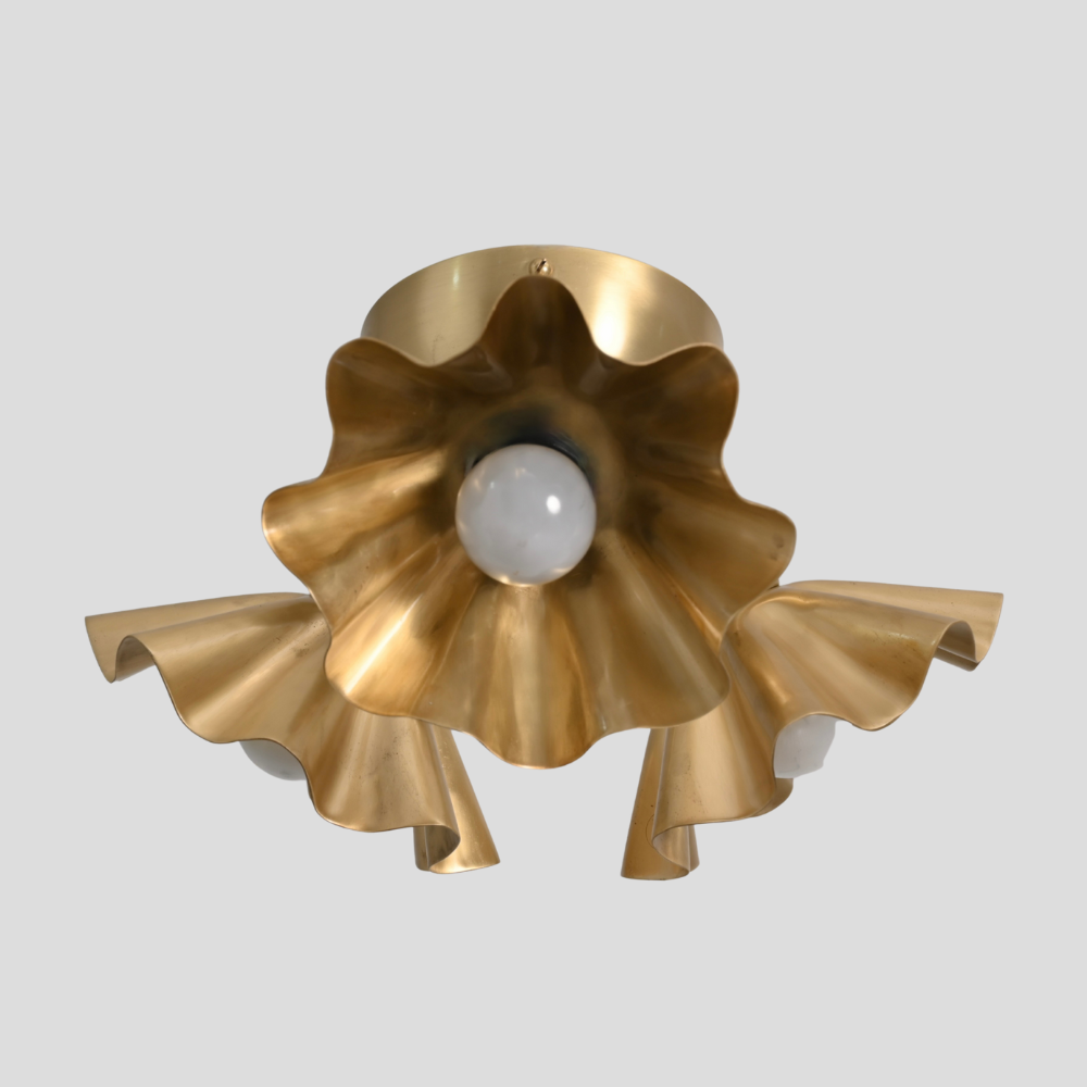 Brass gold 3 light flower flush mount on a gray background 
