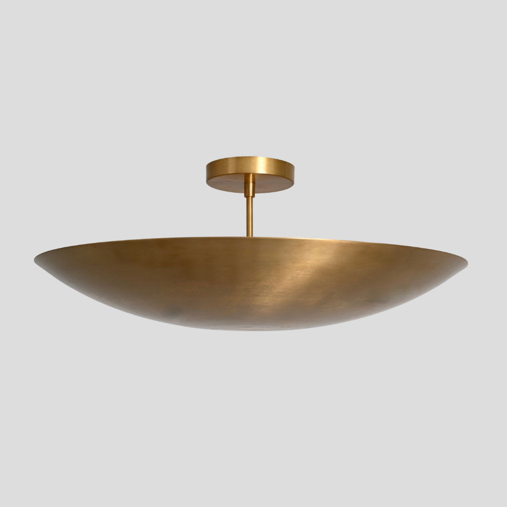 Gold pendant light fixture on a gray background