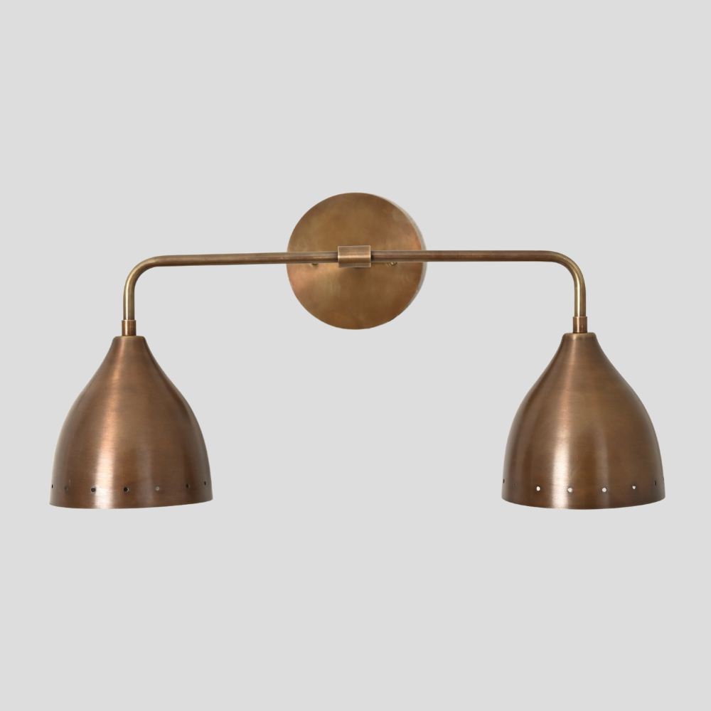 Bronze wall sconce with two lampshades on a light gray background
