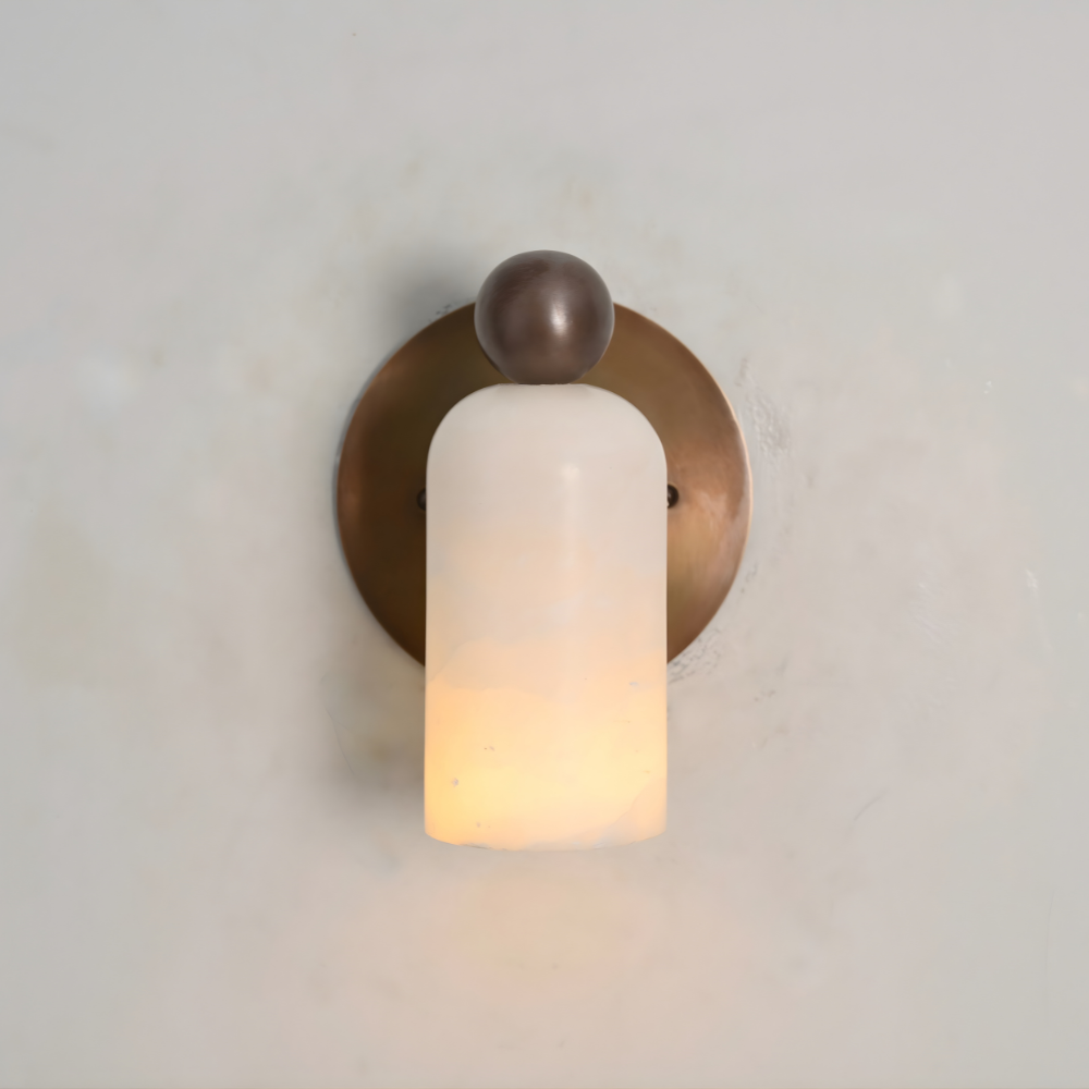 Modern mid century brass ball stub arm and a natural alabaster shade with an warm light 