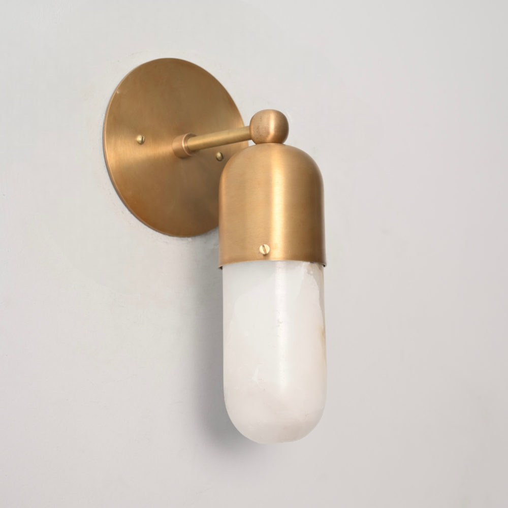 Mid century modern marble capsule wall lamp in raw brass